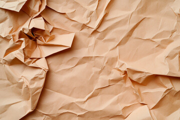 Textured pale orange paper with subtle creases creating a warm, rustic background for artistic...