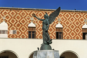 Winged Victory Statue and patterned brick facade facing the harbor of South Aegean Region...