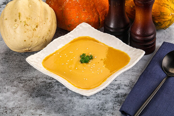 Vegan pumpkin cream soup served sesam