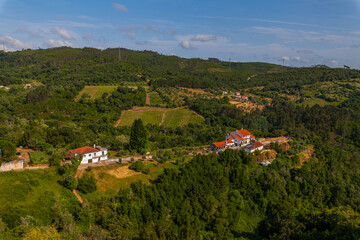 Fototapeta premium A serene rural portuguese landscape featuring a house with a red-tiled roof