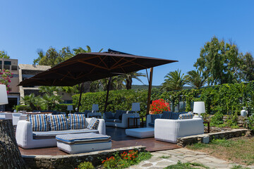 Outdoor patio with sunbeds and umbrellas in luxury resort in Sardinia, Italy