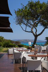 Tables and chairs on the terrace of a restaurant in Sardinia, Italy