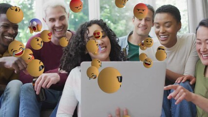 Curly-haired woman holding laptop initiating emoji cascade for tech demo with friends reacting - Powered by Adobe
