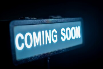 Illuminated Coming Soon sign in moody shadow, heralding new beginnings and the quirky charm of National Novel Writing Month