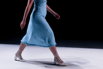 Woman wearing tweed blue dress, classic fashion clothing on black background