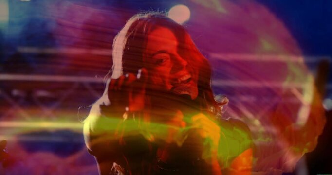 Colored concert lights swirling singer singing into mic, pointing at camera engaging audience
