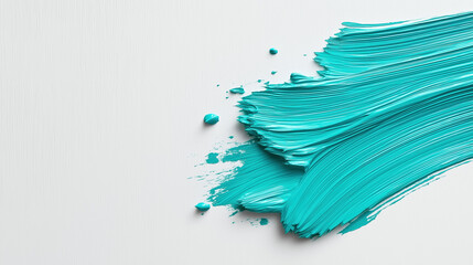 Vibrant turquoise paint strokes on a smooth surface enhance creativity