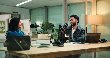 Woman, man and discussion for podcast with microphone, interview or question for studio guest. People, host or artist with online radio show for album promotion, talk or live stream at media company
