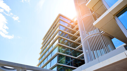 Modern office building with glass facade. Transparent glass wall of office building. Reflection of...