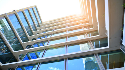 Modern office building with glass facade. Transparent glass wall of office building. Reflection of...