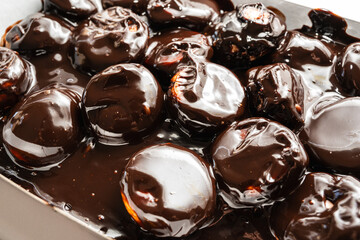 Classic profiteroles coated in rich, glossy dark chocolate sauce