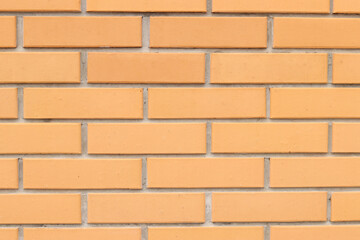Brick wall texture, background. Orange brick wall background for exterior design. Construction concept, outdoor buildings, garage or house. Wall with classic checkerboard pattern and visible joints