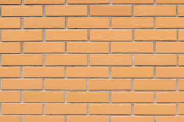 Brick wall texture, background. Orange brick wall background for exterior design. Construction concept, outdoor buildings, garage or house. Wall with classic checkerboard pattern and visible joints
