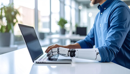 Person with a prosthetic hand typing on a laptop or using a tablet in a modern workspace