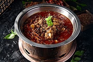 Spicy lamb head with red oil in pot