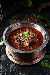 Spicy lamb head with red oil in pot