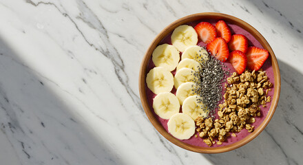 Delicious smoothie bowl with fresh fruit, granola, and chia seeds, ready to eat.