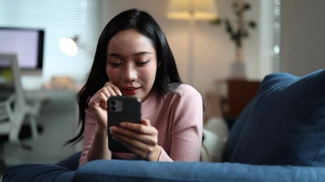 Woman relaxes on a couch, engaging with her phone. Her expressions shift from amused to thoughtful, creating a joyful, relatable scene in a cozy home setting