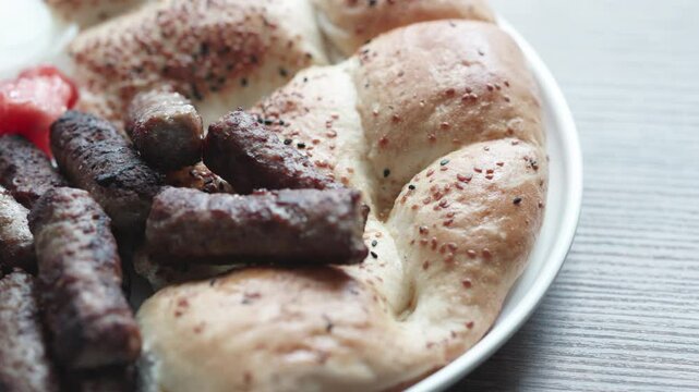 A balkan traditional meatball dish cevapi, cevapcici on wooden table in close-up