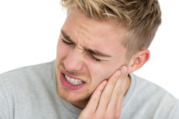 Blonde male with toothache gripping his face in agony showing intense oral pain symptoms, isolated on a transparent background