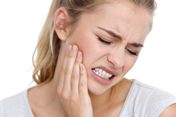 Young blonde woman in white shirt holding jaw in pain, dental toothache expression, isolated on a transparent background