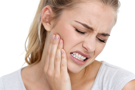 Young blonde woman in white shirt holding jaw in pain, dental toothache expression, isolated on a transparent background - Powered by Adobe