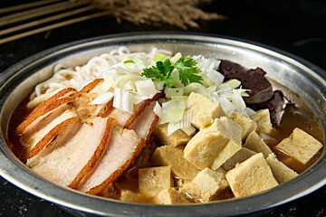 Mongolian cuisine: blood sausage, roasted pork, frozen tofu and vermicelli stew