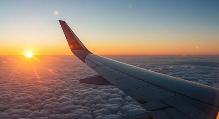 Obraz premium Airplane Wing Soaring Above a Sea of Clouds at Sunset with Golden Light