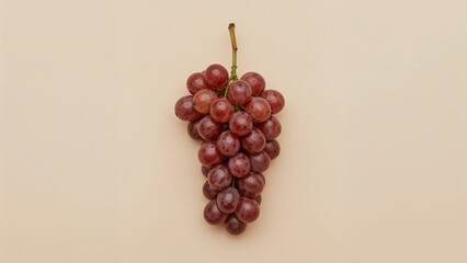 Red grapes cluster on a light beige background.