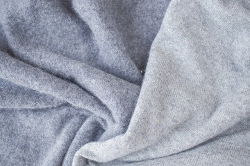 Cashmere gray fabric, top view. Draped, texture, background. Natural wool clothing.