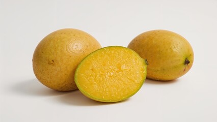 Ripe yellow mangoes, whole and sliced, on a white background.