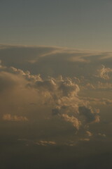 View of clouds out of an airplane porthole at dusk