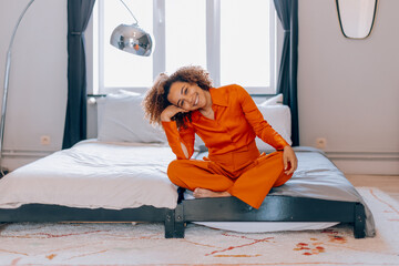 Woman relaxing in modern bedroom setting