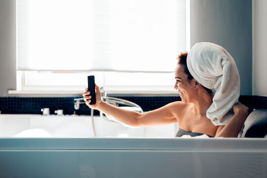 Woman enjoying a relaxing bath selfie moment