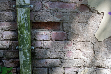 weathered old downspout on the brick wall