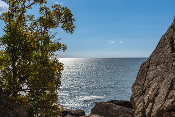 Rocky coast of Black Sea. Coastal scene with steep cliffs and large boulders of Cape Alchak rises...