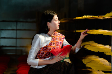 teenage girl dressed in traditional Thai clothing