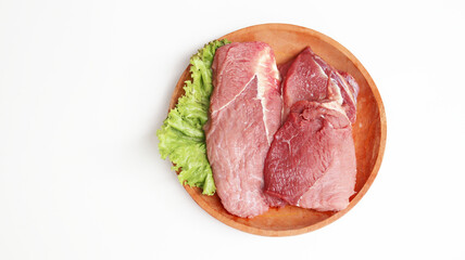 Fresh raw meet on wooden plate isolated on white background 
