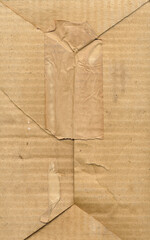 Brown cardboard textured box. Old dirty cardboard surface background. Vintage box with paper tape...