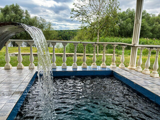 Outdoor Pool Fountain with Scenic Nature View

