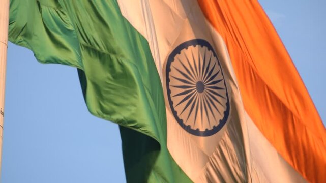 India flag flying high at Connaught Place with pride with plain white background, India flag fluttering, Indian Flag on Independence Day and Republic Day of India, tilt up shot, Har Ghar Tiranga