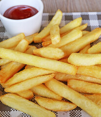 Pile of delectable crispy French fries with flavorful ketchup