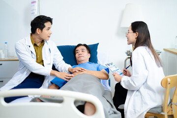 Doctor and nurse warmly support senior patient in hospital bed, discussing diagnosis & care plan.