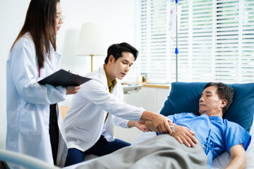 Doctor and nurse warmly support senior patient in hospital bed, discussing diagnosis & care plan.