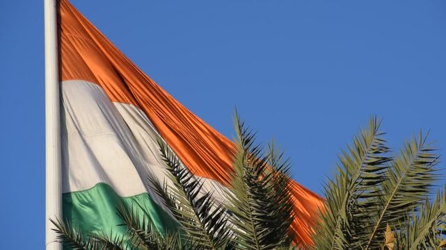 India flag flying high at Connaught Place with pride with plain white background, India flag fluttering, Indian Flag on Independence Day and Republic Day of India, tilt up shot, Har Ghar Tiranga