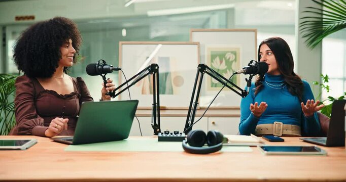 Creative, women and host with mic for content creation, interview and live streaming podcast on web. Happy, people and laughing with guest in studio, conversation and podcaster with laptop for audio