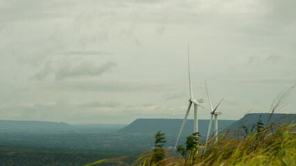 Wind turbines generating clean energy in a rural landscape, symbolizing sustainable development and...