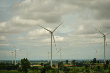 Wind turbines generating clean energy in a rural landscape, symbolizing sustainable development and eco-friendly technology for reducing environmental impact.