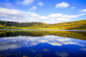 Landscape at the Schalkenmehrener Maar in autumn. View of the idyllic nature by the lake in the Eifel near the Dauner Maar.
