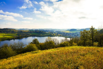 Landscape at the Schalkenmehrener Maar in autumn. View of the idyllic nature by the lake in the...